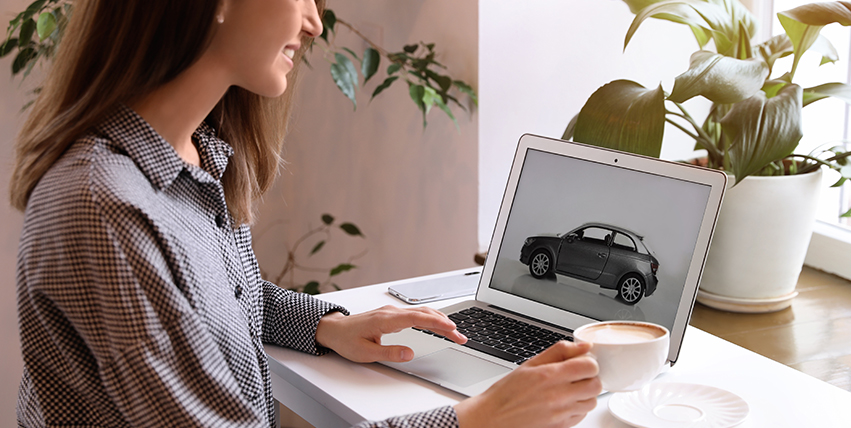 Woman Looking at Car on Her Laptop